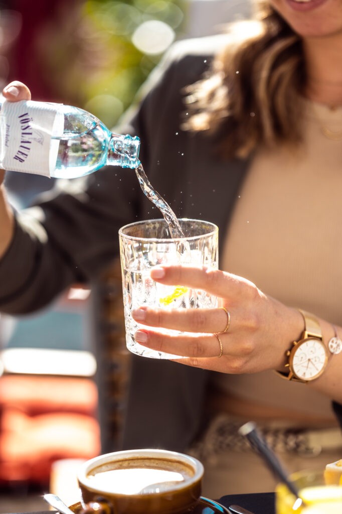 Einschenken von Vöslauer Mineralwasser in Glas bei Café Salitri Hallein